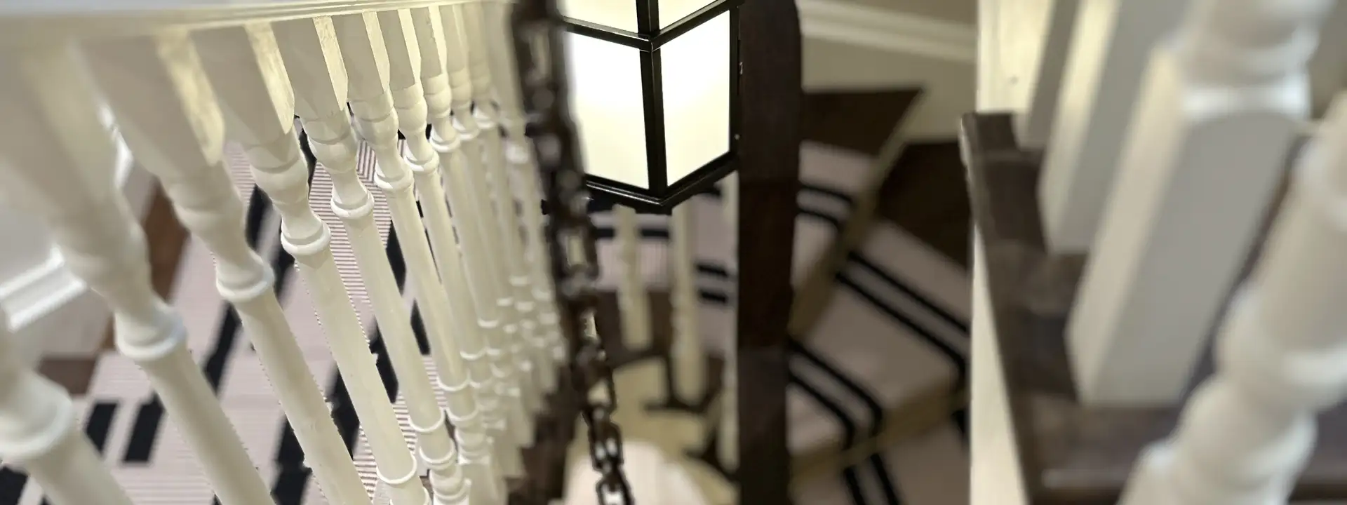 Lantern pendants lighting a sweeping staircase
